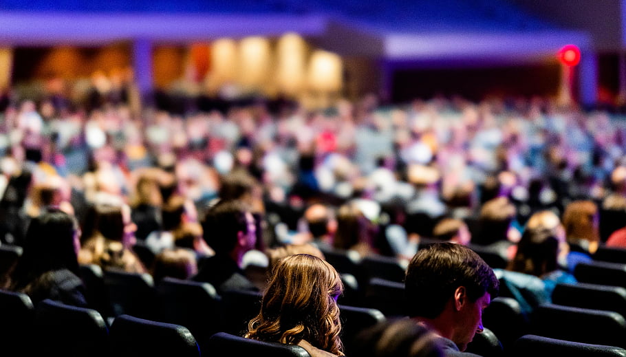 audience-sitting-chairs-indoor-conference-large-crowd-attentively-listening-focus-on-audience-event-conference-hall-attendees